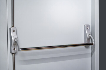 Panic bar door handle on emergency fire exit door in public building