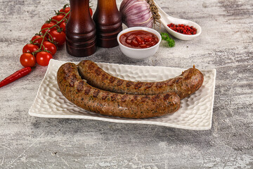 Grilled beef sausages with sauce
