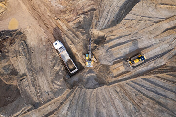 aerial view of quarry. excavator loading sand into dump truck