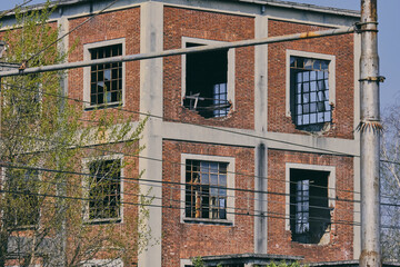 Abandoned Industrial Chimney Tower with Overgrown Vegetation