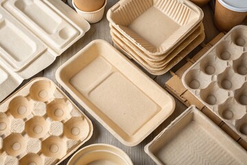 Top view of various biodegradable disposable tableware made from cardboard pulp