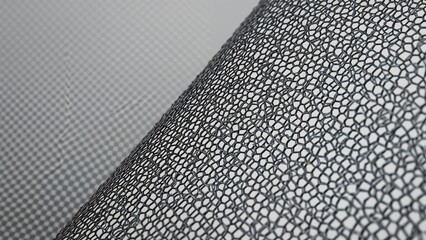 Close-up shot of a thin metal grid with numerous tiny openings