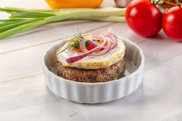 Beefsteak chop with roasted egg