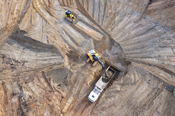 aerial view of quarry. excavator loading sand into dump truck