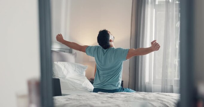 Stretching, wake up and back with man in bedroom for morning routine, relax and health. Start of day, comfortable and wellness with male person in bed of home for peace, calm and muscle relief