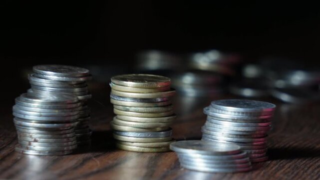 Business women hand placing and counting a stack of coins  also called rupees or paisa