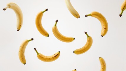 Juicy baby bananas drifting in the air on a plain white background, conveying levitation of fruits in a sharp, high-quality photograph