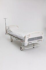 A Hospital Bed featuring an IV Stand designed for use in a Clinical Setting for patients