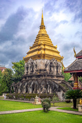 Fototapeta premium Vertical view of the Buddhist temple Chedi Chan Lom or Elephant Chedi at Wat Chiang Man in Chiang Mai, Thailand