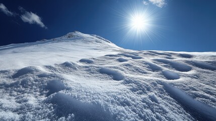 Snow-covered mountain landscape under bright sun