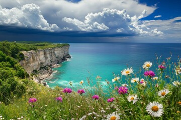 Wildflowers bloom vibrantly at the edge of a coastal cliff while turquoise waves crash below. A dramatic sky enhances the stunning vista, creating a breathtaking natural landscape