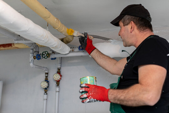 A Professional Worker Engaged in Repairing Pipes Inside a Residential Building Today