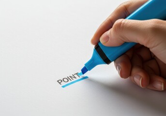 Hand highlighting the word point on a white surface with a blue highlighter