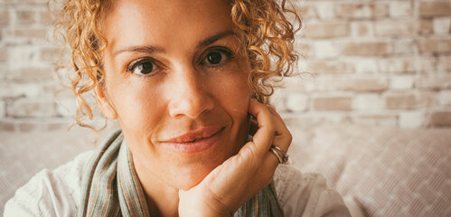 Middle-aged woman at home enjoying leisure time, using smartphone, dancing, surrounded by plants, smiling and relaxed, independent lifestyle, having fun, personal freedom, carefree and joyful moments