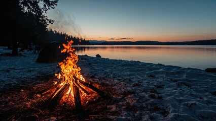 Cozy lakeside fire blazing with sparks on a cold winter evening