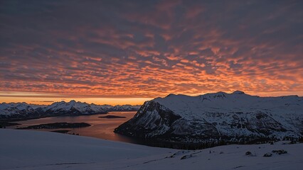 Charming frosty scenery with radiant sky hues illuminating snowy hills and fjord waters