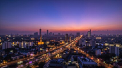 Fototapeta premium Blurred luminescence in a purple-filtered cityscape highlighting a significant bridge.