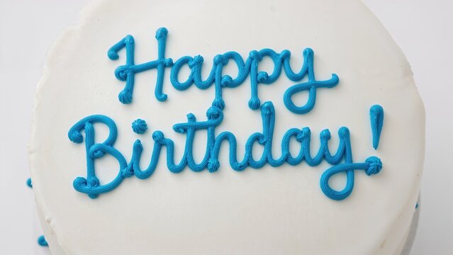 Happy Birthday written in blue buttercream frosting