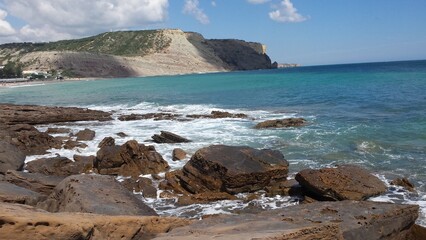 Tall sandstone cliffs rising from the water.