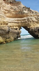 Tall sandstone cliffs rising from the water.