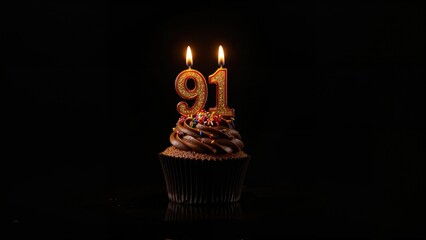 Number 91 birthday candles atop a cupcake on a dark surface