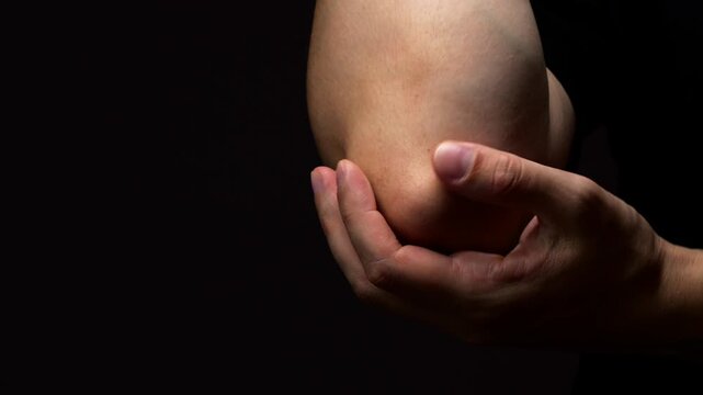 Man in black t-shirt experiences severe pain in arm and elbow joint after physical activity.
Fatigue and pain in arm.
Pinched nerve or joint in arm.
Pain, elbow, arm, body