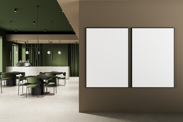Modern restaurant interior with two empty framed posters on brown wall and green decor concept for design mockup and layout template display idea. 3D Rendering