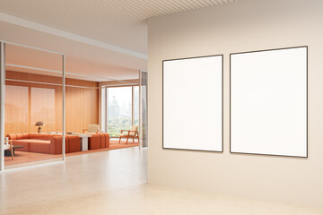 Two blank framed posters on clean wall in modern office interior with cozy orange lounge area and city view through glass partition. 3D Rendering