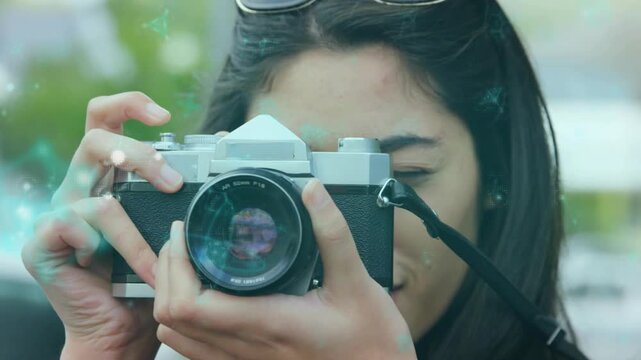 Amateur photographer lifting vintage film camera, adjusting focus ring and capturing street scene