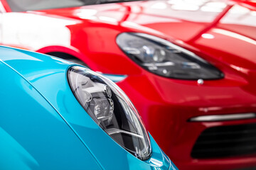 Car headlight of blue  and red automobile.