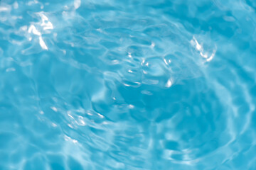 Blue water with ripples on the surface. Defocus blurred transparent blue colored clear calm water...