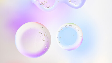 Semi-transparent bubbles with soft rainbow hues on a light artistic background. Modern abstract art