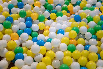 Colorful plastic balls toy for children at playground. Sport and recreation object, selective focus.