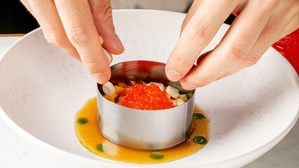 Delicate hands craft alluring salmon roe tartare, culinary artistry, gourmet expressions,...