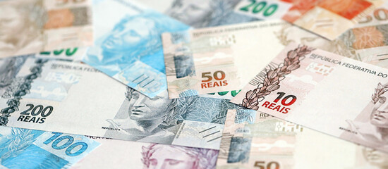 Brazilian reais banknotes. The current Brazil real money bills lies on table in big amount