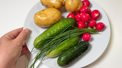 Unearthed treasures on a plate; rustic potatoes, vibrant radishes, and emerald cucumbers evoke Slavic harvest tales and Ukha celebrations