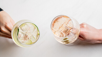 Clinking glasses in a frosty toast, translucent spirits celebrate World Cocktail Day and poetic...