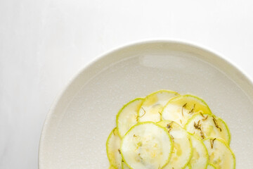 Thin zucchini slices artfully arranged, embodying crisp freshness, perfect for a minimalist Zen celebration or an avant-garde culinary fest