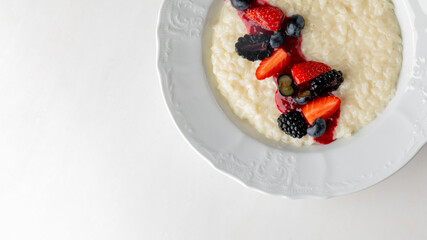 Creamy rice pudding crowned with a burst of wild berries evokes midsummer night's dreams and joyous harvest festivals