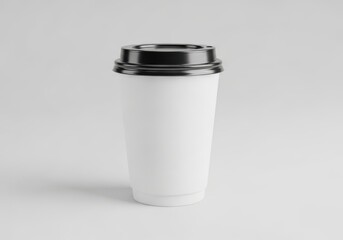 A white paper coffee cup with a black lid isolated on a light background
