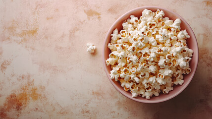 Bowl of popcorn on a textured beige background.