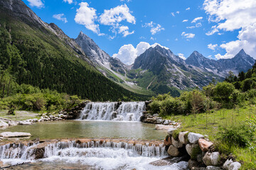 Beautiful summer landscape of Bipenggou National Park, featuring green mountains and small...