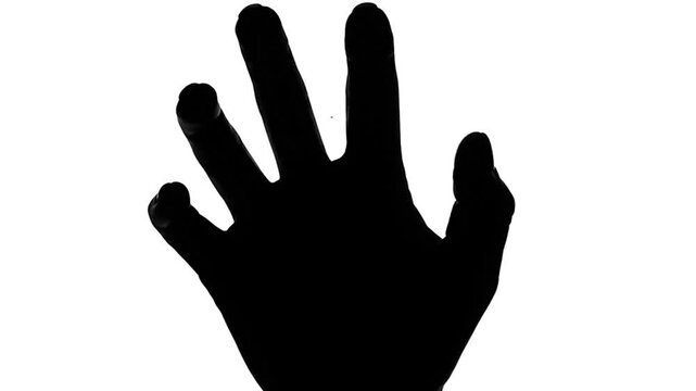 A stark silhouette of a hand with fingers spread against a white background