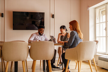 Team of professionals discussing and planning in office during meeting collaborating on strategies and business goals