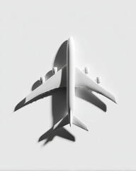 Aerial view of white airplane silhouette casting soft shadows on light background, creating minimalist and modern aesthetic