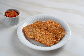 Tempeh, Tempe Goreng or Fried tempeh is Indonesia traditional food, made from fermented soybean seeds. Perfect for recipes, articles or any cooking content.