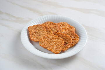 Tempeh, Tempe Goreng or Fried tempeh is Indonesia traditional food, made from fermented soybean seeds. Perfect for recipes, articles or any cooking content.