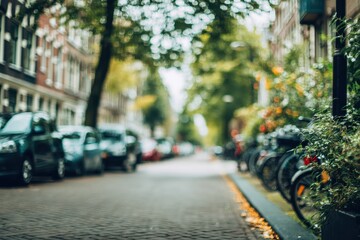 Blurred European street scene, parked cars, trees