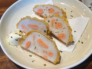 Tempura-style lotus root filled with spicy mentaiko roe, offering a crunchy bite with a savory kick.