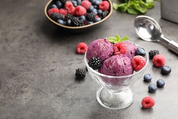 Delicious sorbet with fresh berries and mint in dessert bowl on grey textured table, closeup